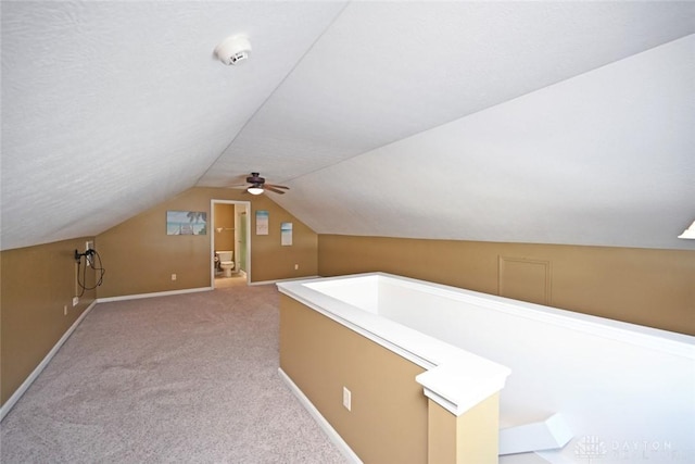 additional living space with ceiling fan, lofted ceiling, and carpet flooring