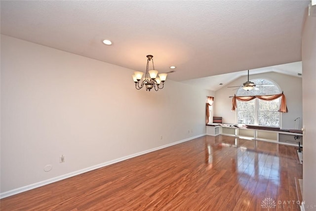 interior space with lofted ceiling, ceiling fan with notable chandelier, and wood-type flooring