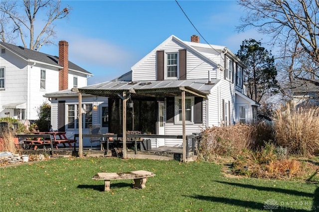 rear view of property featuring a yard