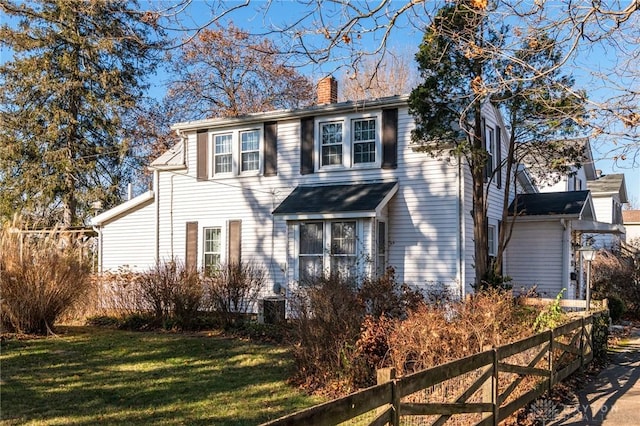 colonial inspired home with a front lawn