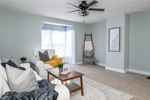 living room featuring light carpet, a textured ceiling, and ceiling fan