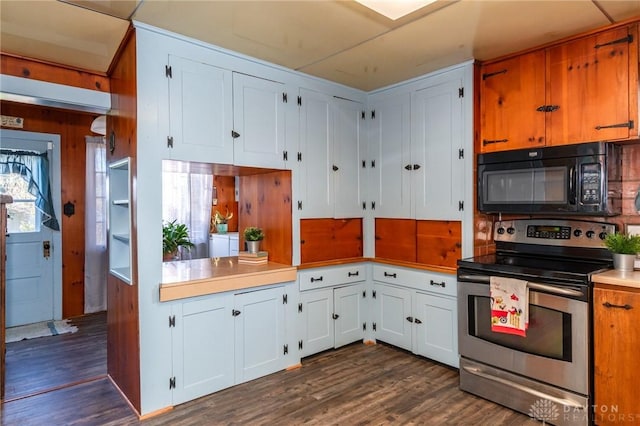 kitchen with white cabinetry, backsplash, dark wood-type flooring, and stainless steel electric stove