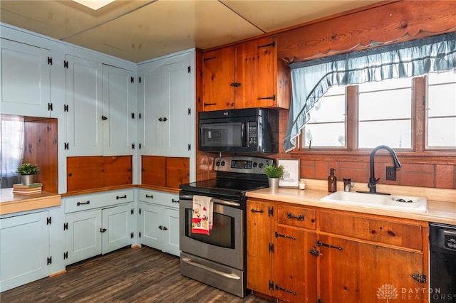 kitchen featuring white cabinetry, dark wood-type flooring, sink, and black appliances