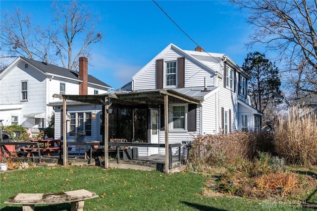 rear view of property with a yard