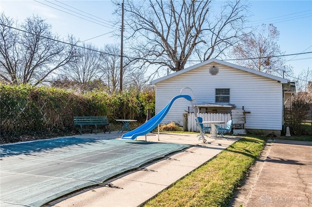 view of playground with a patio