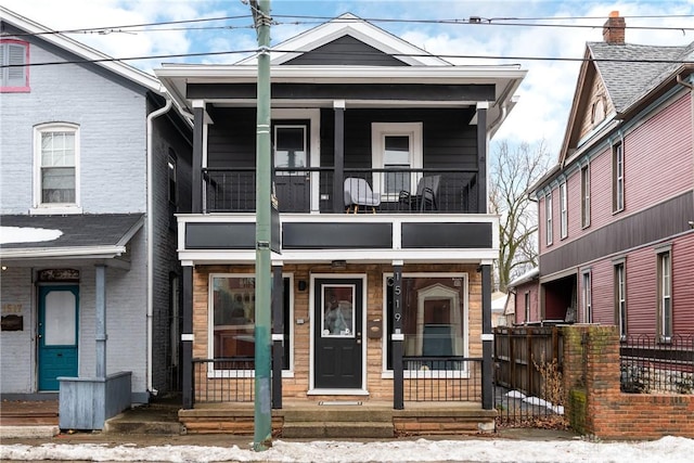 view of front of home with a balcony and covered porch