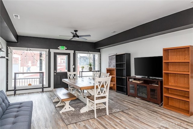 dining area with ceiling fan and wood-type flooring