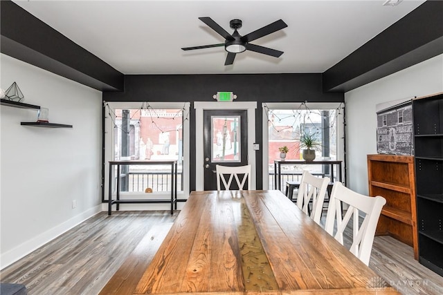 unfurnished dining area with ceiling fan and wood-type flooring