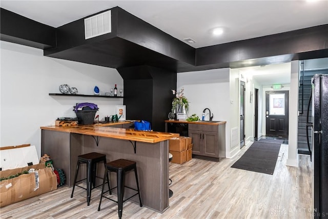 bar with light hardwood / wood-style flooring