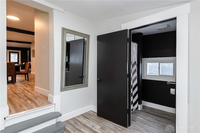 corridor with hardwood / wood-style floors