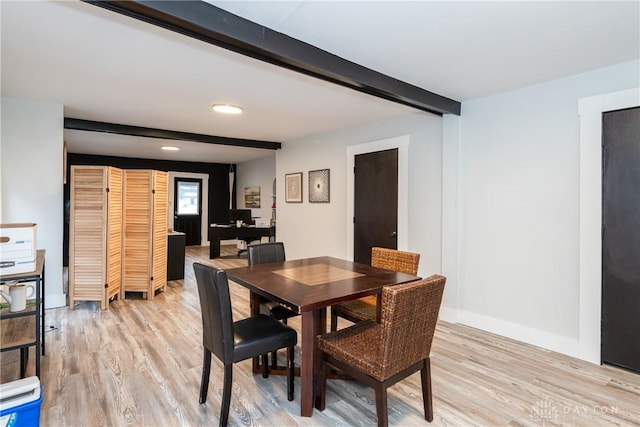 dining room with beam ceiling and light hardwood / wood-style flooring