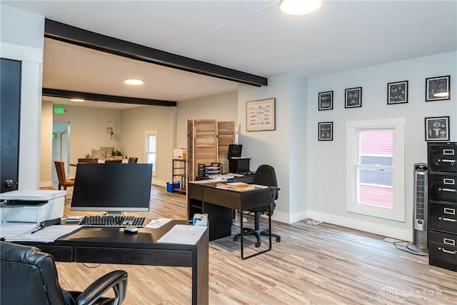 home office with light hardwood / wood-style flooring, beam ceiling, and plenty of natural light