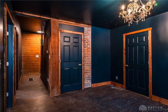 entrance foyer with dark wood-type flooring and a chandelier