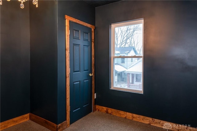 spare room featuring baseboards and carpet floors