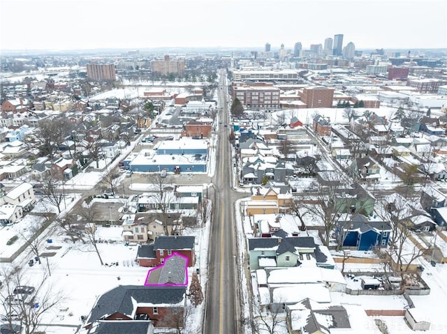 snowy aerial view featuring a city view