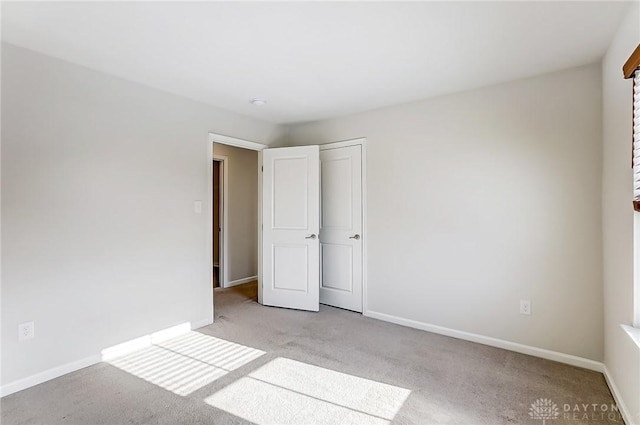 unfurnished bedroom featuring light colored carpet