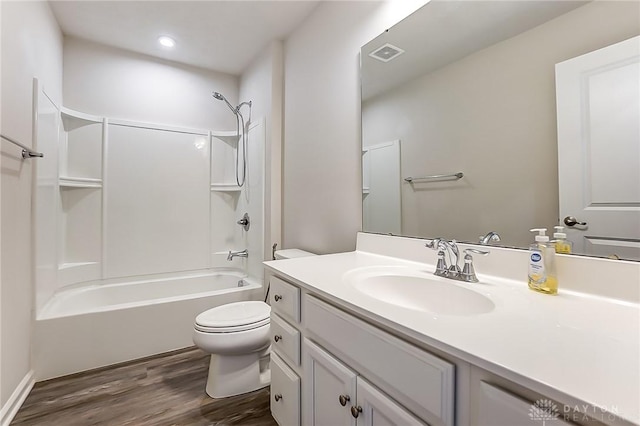 full bathroom with vanity, hardwood / wood-style flooring, shower / tub combination, and toilet