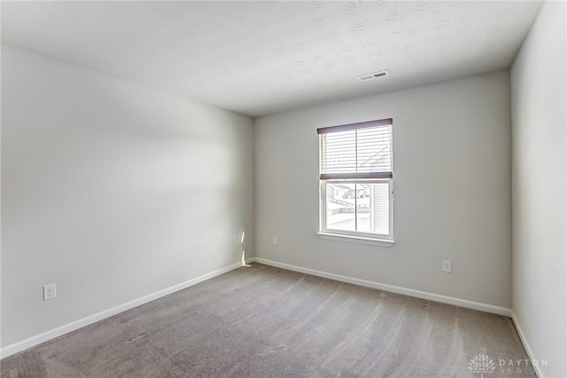 unfurnished room featuring carpet