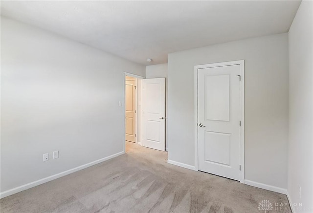 unfurnished bedroom with light carpet