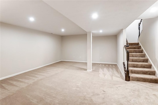 basement featuring light carpet