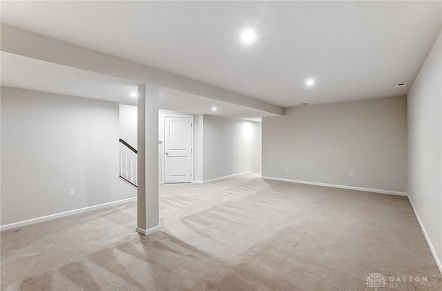 basement featuring light carpet