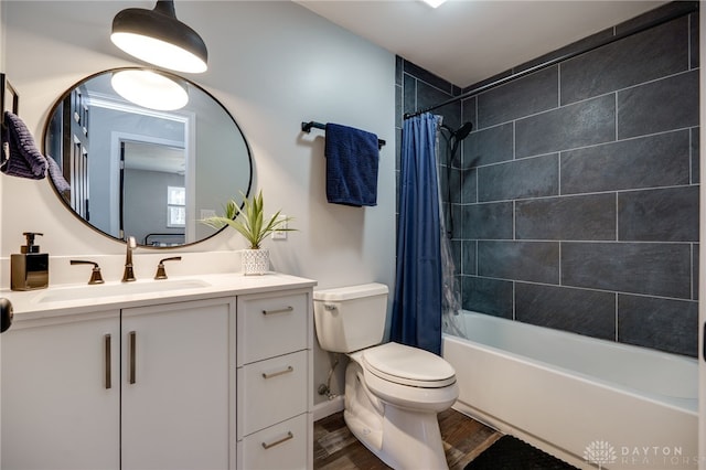 full bathroom featuring hardwood / wood-style flooring, shower / tub combo with curtain, vanity, and toilet