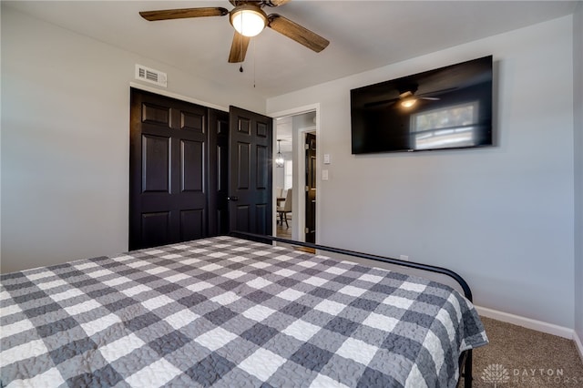 unfurnished bedroom with carpet floors, ceiling fan, and a closet