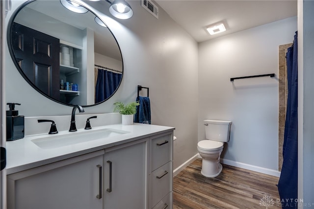 bathroom with vanity, hardwood / wood-style flooring, and toilet