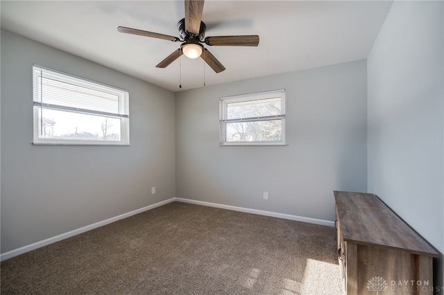 carpeted spare room with ceiling fan and a healthy amount of sunlight