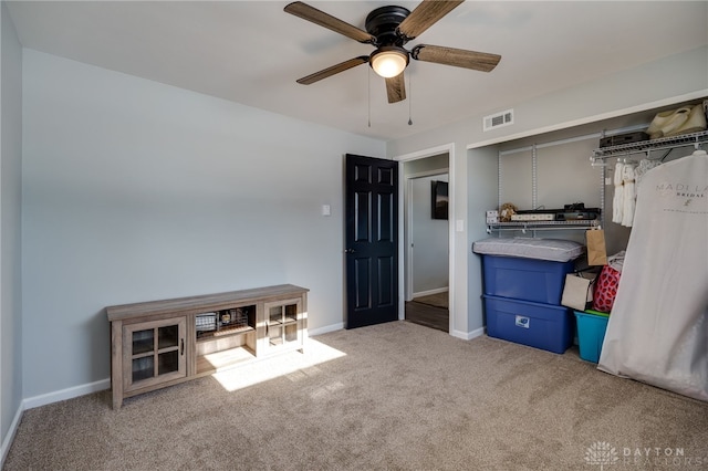 interior space with ceiling fan and a closet