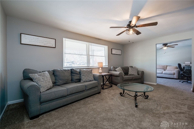 carpeted living room with ceiling fan