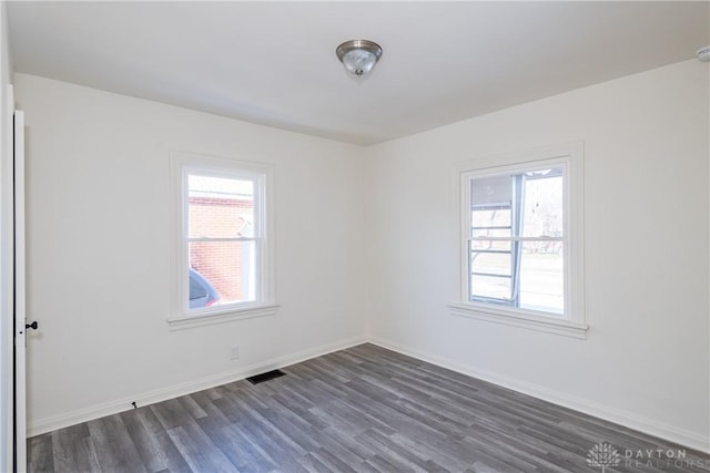 unfurnished room featuring dark hardwood / wood-style floors