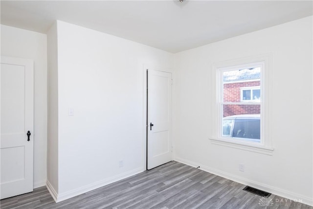 empty room with hardwood / wood-style flooring