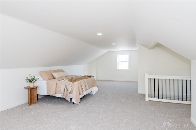 carpeted bedroom with vaulted ceiling