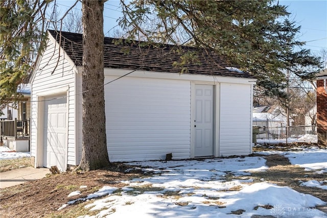 snow covered structure with a garage