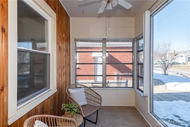 sunroom featuring ceiling fan