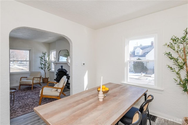 dining area with hardwood / wood-style floors and a textured ceiling