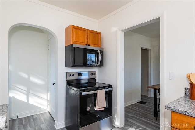 kitchen featuring ornamental molding, dark hardwood / wood-style flooring, light stone counters, and stainless steel electric range