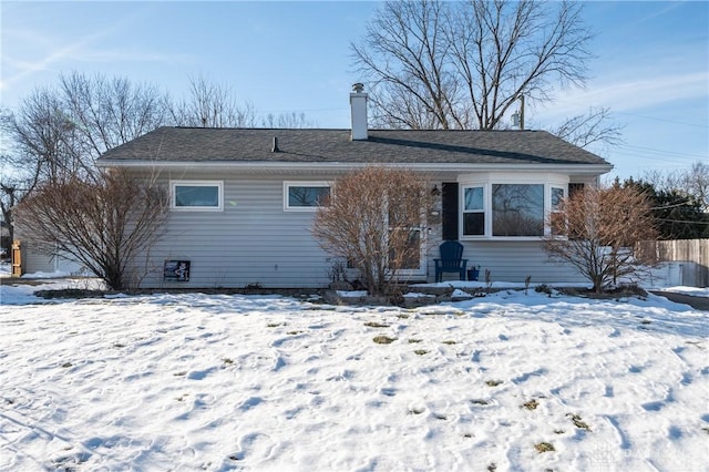 view of snow covered rear of property