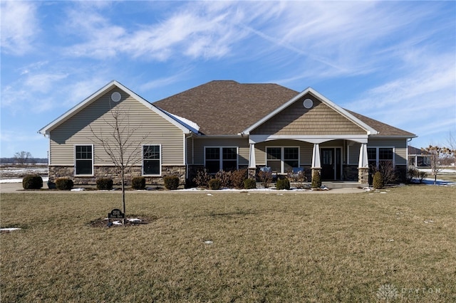 view of front of home with covered porch and a front lawn