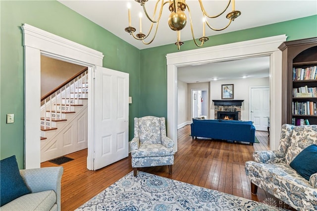 1311 US Route 50, Miami Township, OH 45150 - living room with hardwood / wood-style flooring, a brick fireplace, stairway, and a chandelier