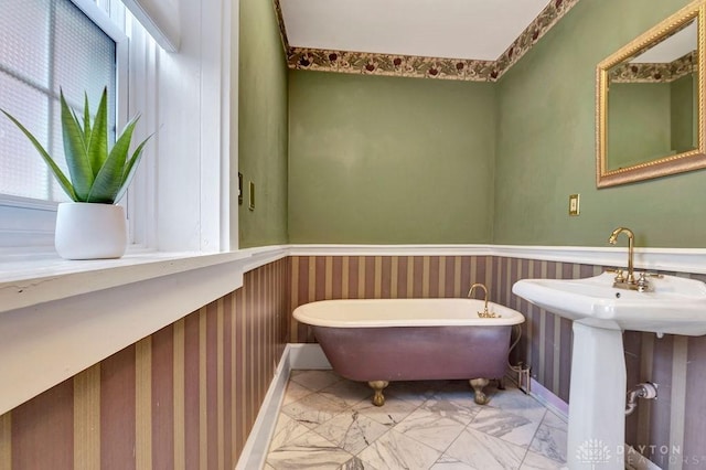 1311 US Route 50, Miami Township, OH 45150 - bathroom featuring a freestanding bath, a wainscoted wall, and marble look tile flooring
