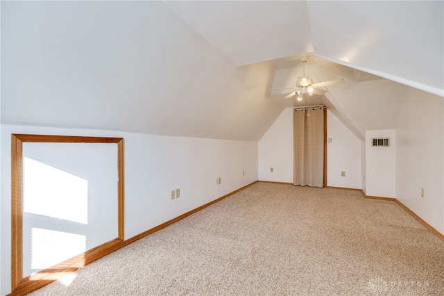 bonus room featuring lofted ceiling, carpet floors, and ceiling fan