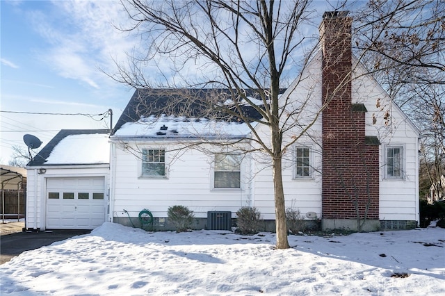 view of front of property featuring a garage and central air condition unit