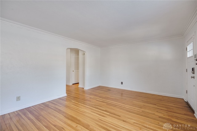 empty room with light hardwood / wood-style flooring and ornamental molding