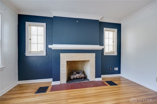 living room featuring ornamental molding, wood-type flooring, and a healthy amount of sunlight