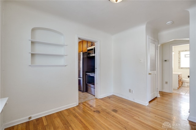 unfurnished room featuring light wood-type flooring