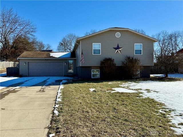 split level home with a garage and a front yard