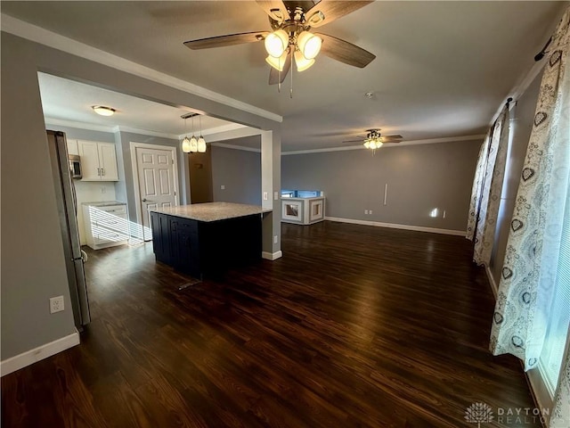 kitchen with crown molding, appliances with stainless steel finishes, dark hardwood / wood-style floors, a center island, and white cabinets