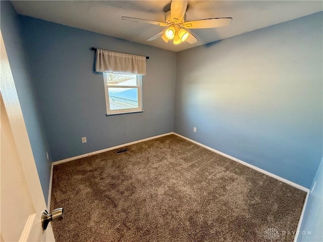 empty room featuring carpet and ceiling fan